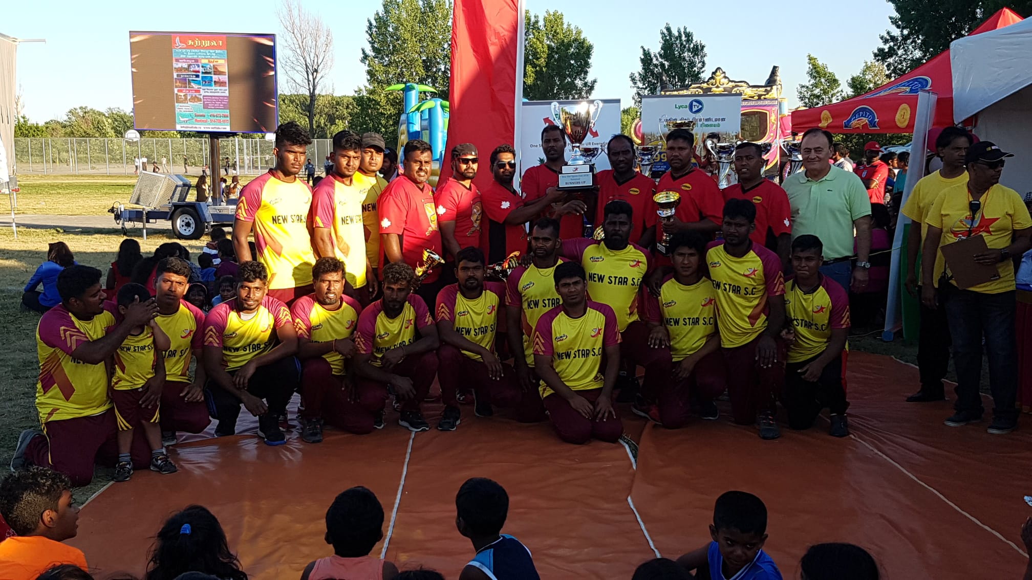 Players in red and yellow jerseys celebrating at a CTVA awards ceremony